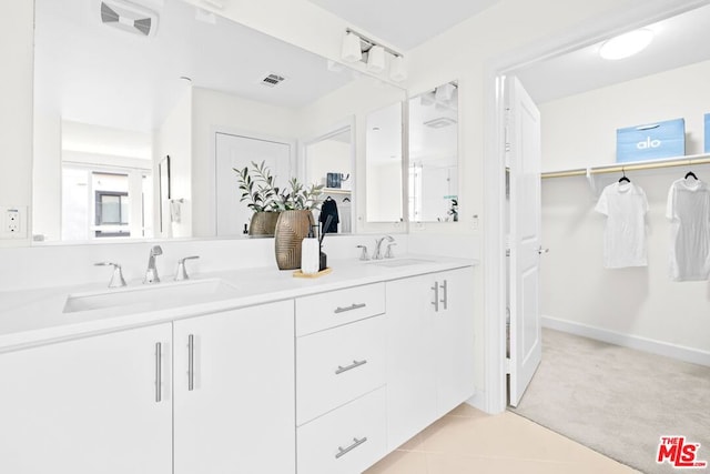 bathroom featuring tile patterned flooring and vanity