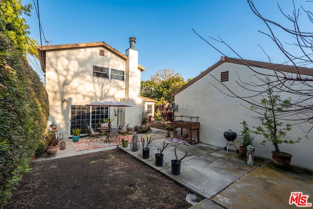 rear view of property with a patio