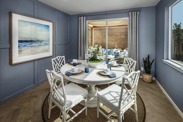 dining room featuring parquet floors