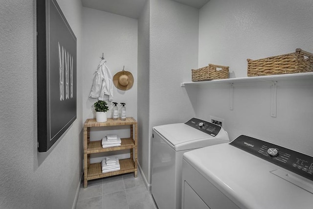 laundry room with washer and dryer and light tile patterned floors