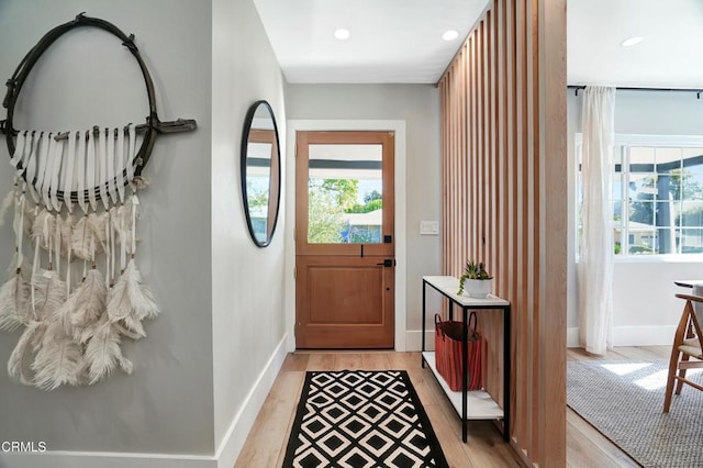 doorway with light wood-type flooring