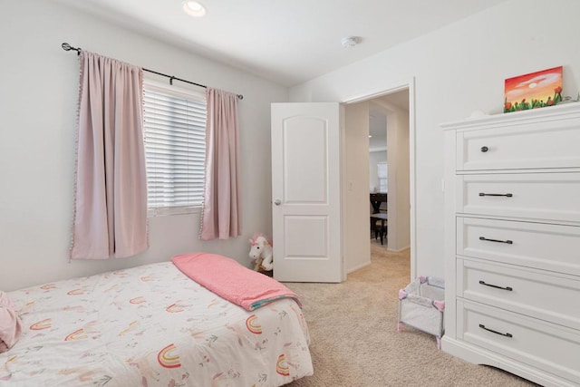 bedroom featuring light carpet