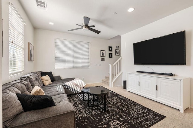 carpeted living room featuring ceiling fan