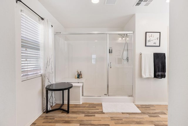 bathroom with hardwood / wood-style floors and walk in shower