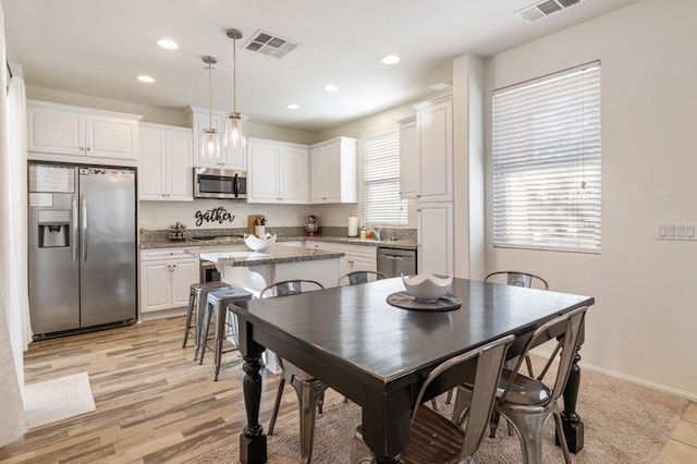 dining room featuring light hardwood / wood-style flooring