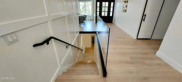 stairs featuring hardwood / wood-style floors