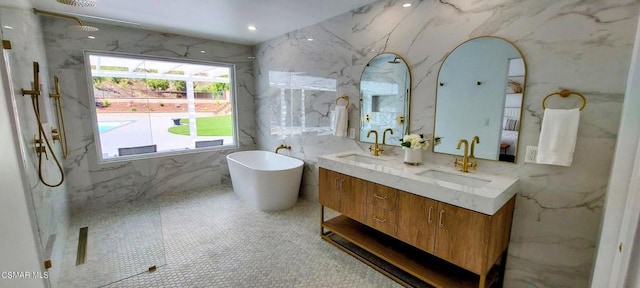 bathroom featuring vanity, shower with separate bathtub, and tile walls