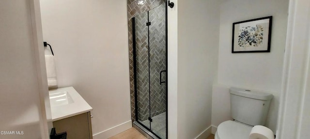 bathroom with walk in shower, vanity, and toilet