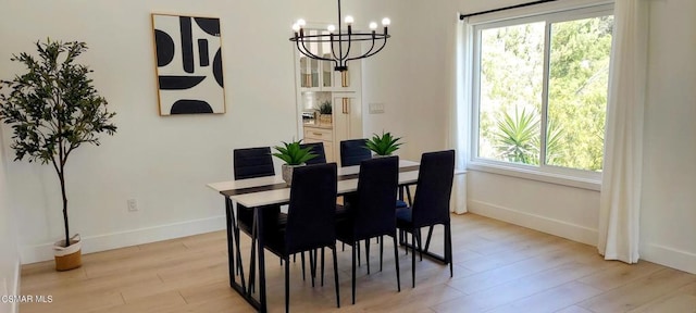 dining area featuring a chandelier and light hardwood / wood-style flooring