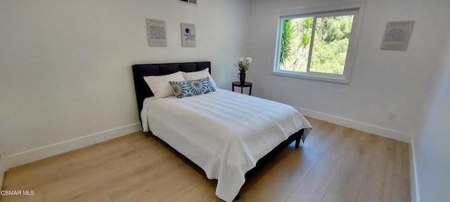 bedroom with hardwood / wood-style floors