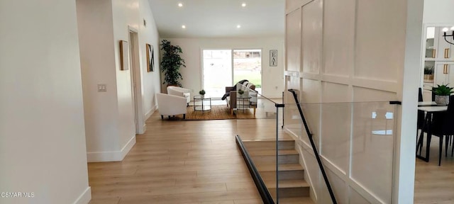 hallway with light hardwood / wood-style flooring