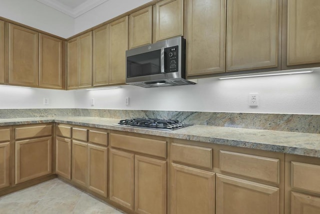 kitchen featuring crown molding, appliances with stainless steel finishes, and light tile patterned flooring