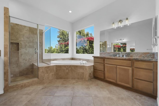 bathroom featuring tile patterned floors, plus walk in shower, and vanity