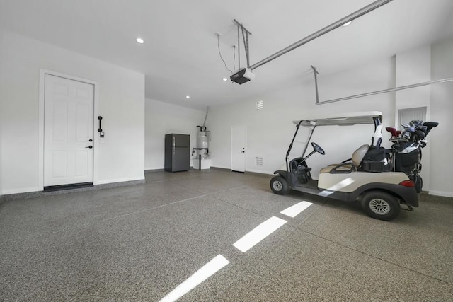 garage featuring a garage door opener and black fridge