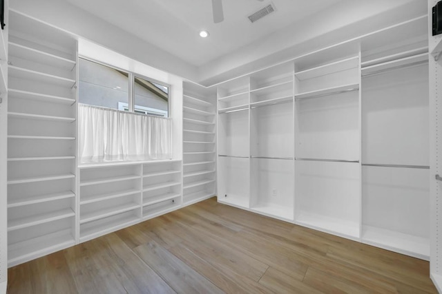 spacious closet with ceiling fan and wood-type flooring