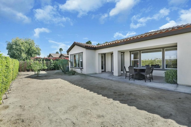 rear view of property featuring a patio area