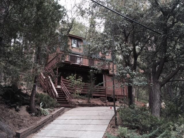 rear view of house featuring a wooden deck