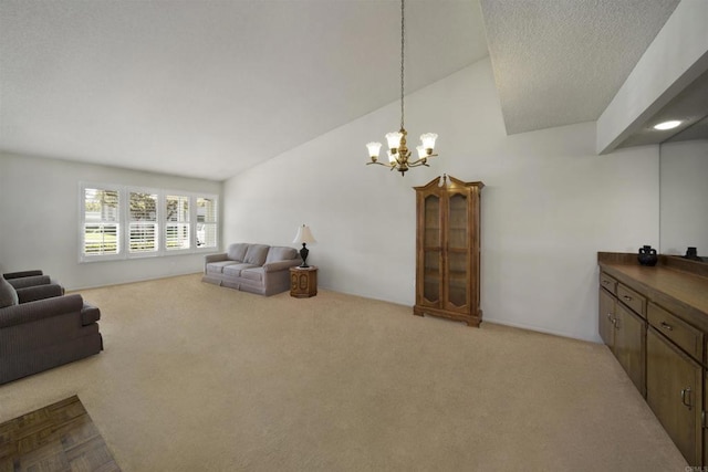 living room featuring lofted ceiling, light colored carpet, and a chandelier