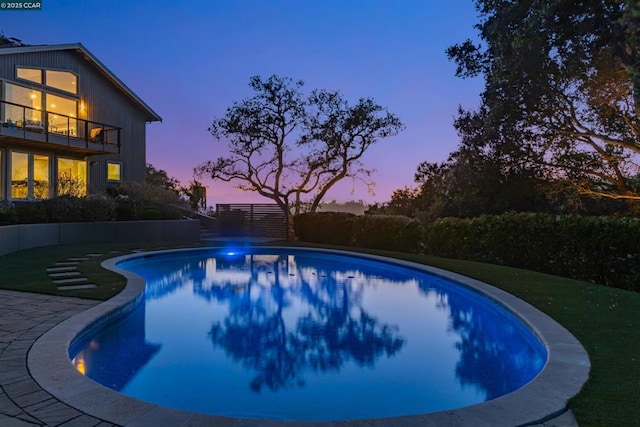 view of pool at dusk