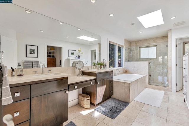 bathroom featuring vanity, a skylight, and plus walk in shower