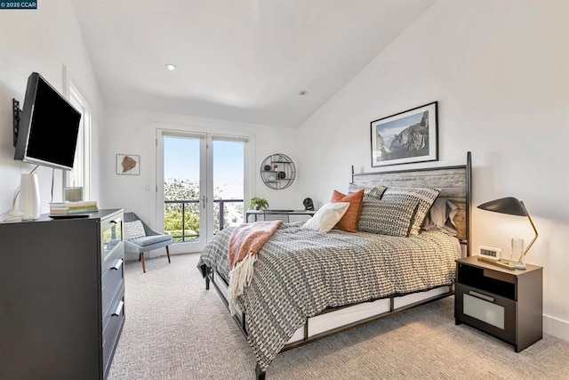 bedroom featuring lofted ceiling, access to exterior, and light carpet