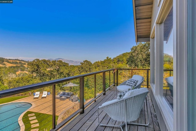 wooden terrace with an outdoor hangout area and a mountain view