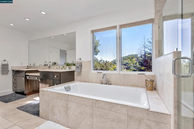 bathroom featuring vanity, tiled tub, and tile patterned floors