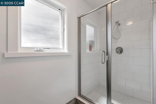 bathroom with a shower with door