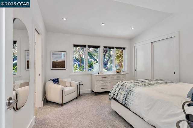 bedroom featuring light colored carpet and a closet