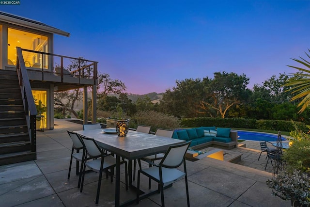 patio terrace at dusk featuring an outdoor hangout area