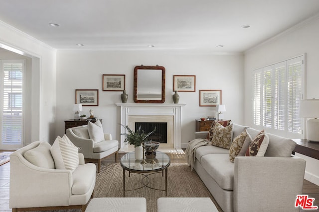 living room with wood-type flooring and ornamental molding