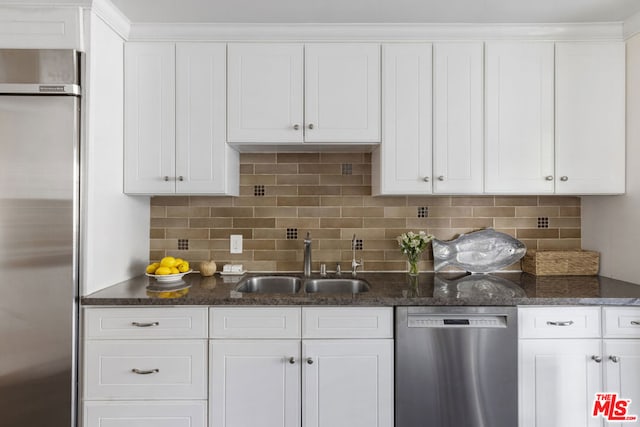 kitchen with white cabinetry, sink, tasteful backsplash, and appliances with stainless steel finishes