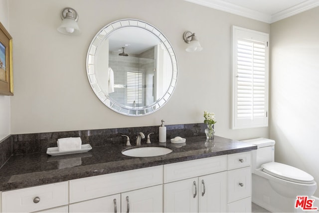 bathroom with vanity, crown molding, and toilet