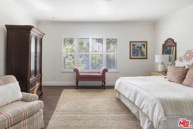 bedroom with crown molding and dark hardwood / wood-style floors