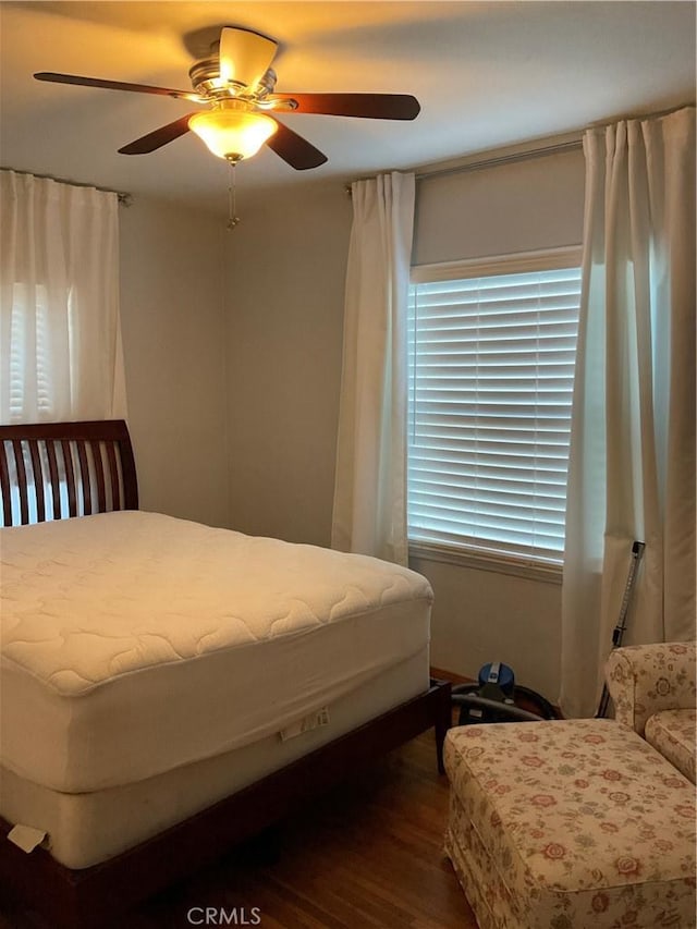 bedroom with hardwood / wood-style flooring and ceiling fan