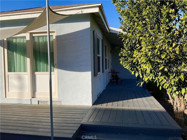 view of property exterior with a deck