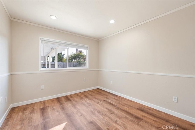 spare room with hardwood / wood-style floors and ornamental molding