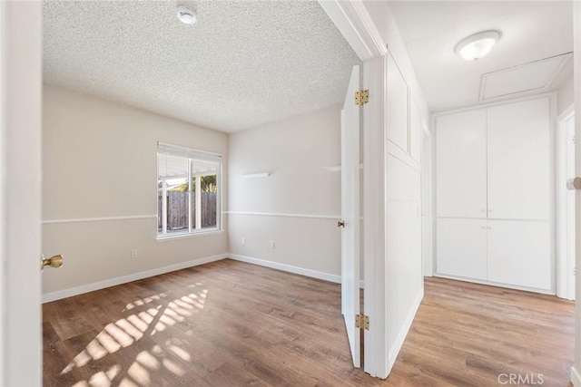 interior space featuring hardwood / wood-style flooring and a textured ceiling