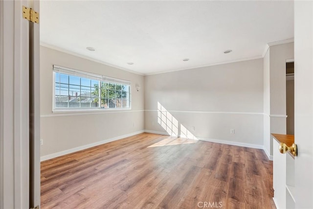 unfurnished room featuring crown molding and hardwood / wood-style flooring