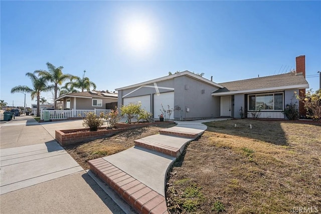 view of front of property with a garage and a front yard