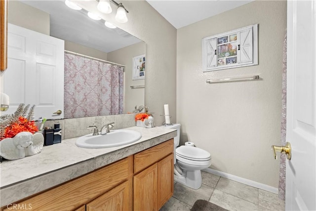 bathroom with vanity, tile patterned flooring, and toilet