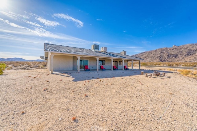 view of front of house featuring central AC and a mountain view