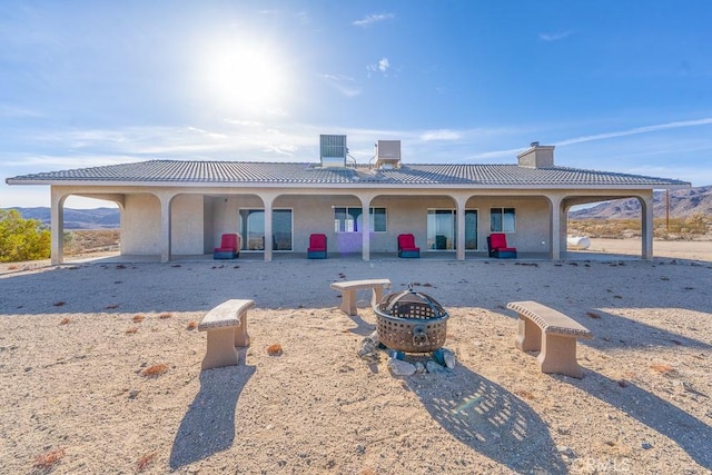 view of front of house featuring an outdoor fire pit