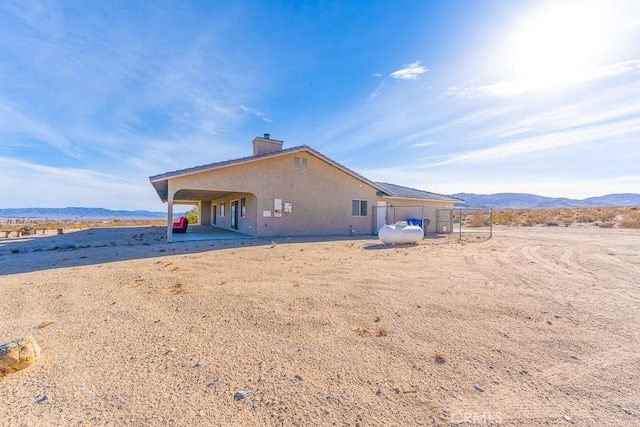 rear view of property with a mountain view