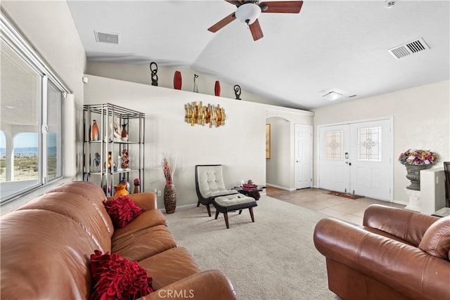 living room featuring vaulted ceiling, light carpet, and ceiling fan