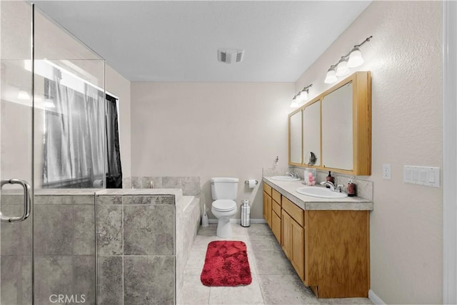 bathroom featuring tile patterned floors, vanity, and toilet