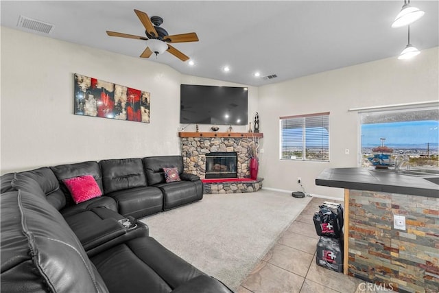 tiled living room with ceiling fan, a fireplace, and sink