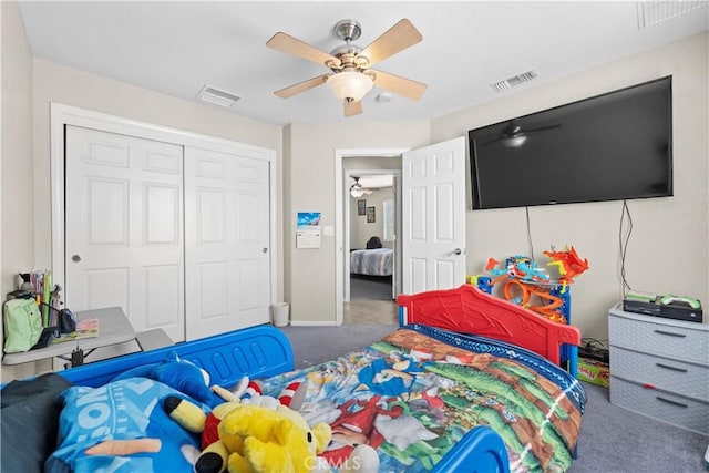 carpeted bedroom featuring a closet and ceiling fan