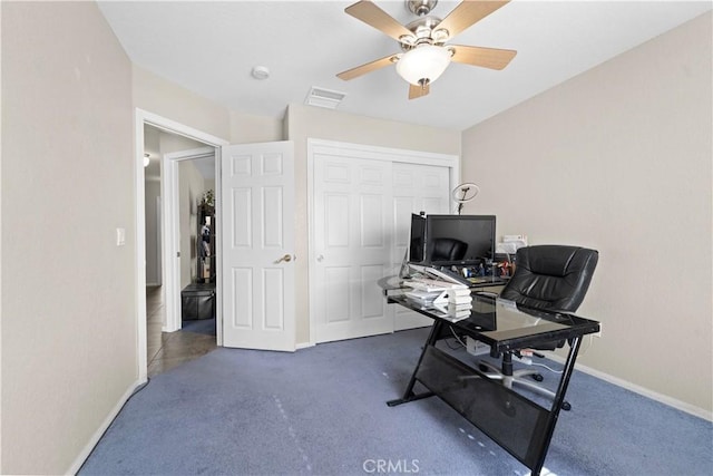 office with dark colored carpet and ceiling fan