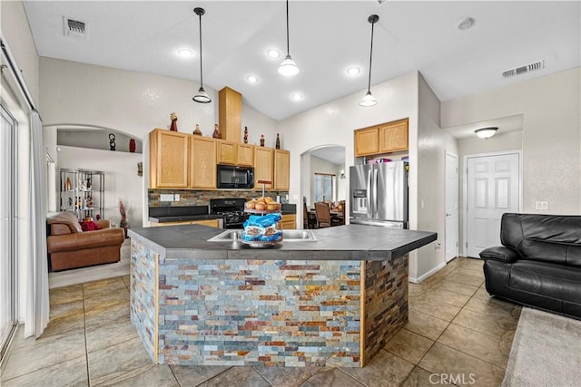 kitchen with lofted ceiling, light brown cabinets, pendant lighting, decorative backsplash, and black appliances